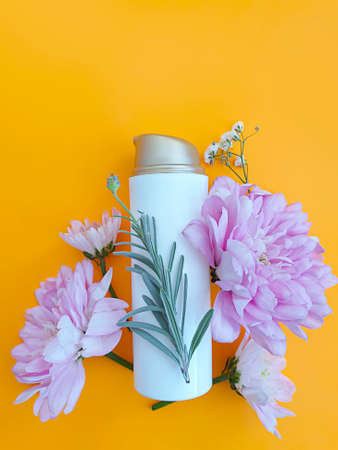 cosmetic cream, flower on a colored backgroundの写真素材