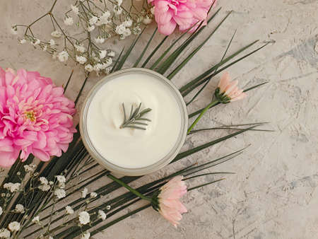 cosmetic cream, flower on on a concrete backgroundの写真素材