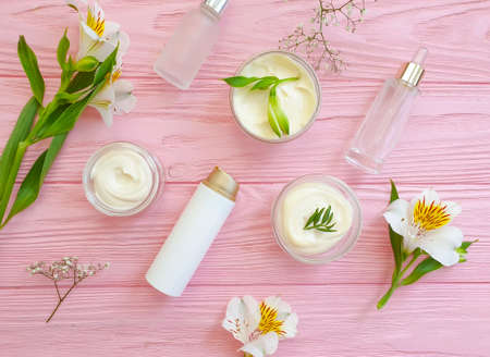 cosmetic cream, flower on on a wooden backgroundの写真素材