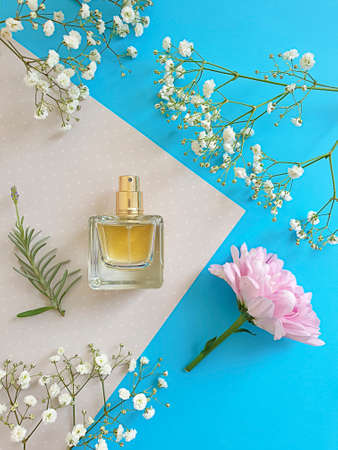 bottle perfume flower on a colored background