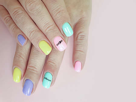 female hand beautiful manicure on a colored background