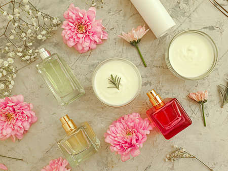 cosmetic cream, flower on a concrete background
