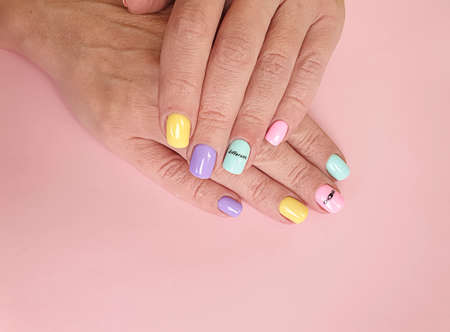 female hand beautiful manicure on a colored backgroundの写真素材