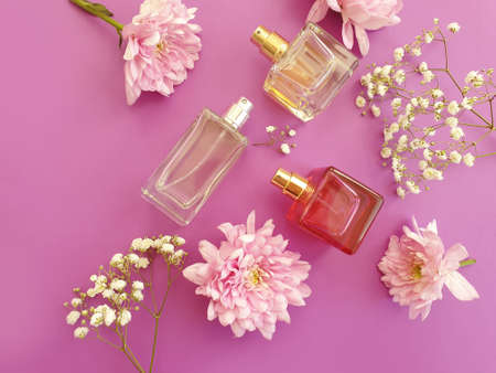 bottle perfume flower on a colored background