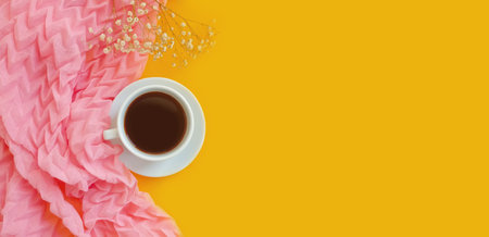cup of coffee, a scarf on a colored background, gypsophila flower, morning