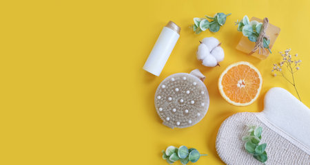 massage brush, soap on a colored background