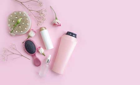 shampoo, massage brush, comb flower on a colored backgroundの写真素材