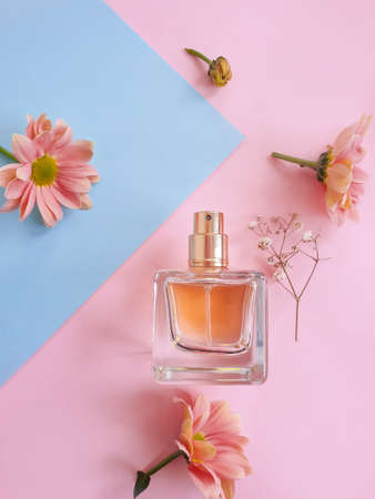 bottle perfume flower on a colored backgroundの写真素材