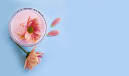 cosmetic cream,  flower on a colored backgroundの写真素材