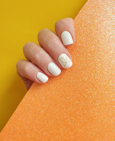 female hand beautiful manicure on a colored backgroundの写真素材