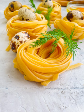raw pasta, quail egg on a concrete backgroundの写真素材