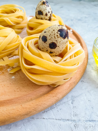 raw pasta, quail egg on a concrete backgroundの写真素材