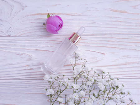 cream cosmetic gypsophila, rose flower on wooden backgroundの写真素材