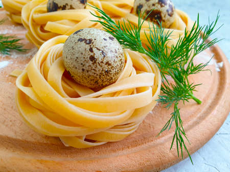 raw pasta, quail egg on a concrete backgroundの写真素材