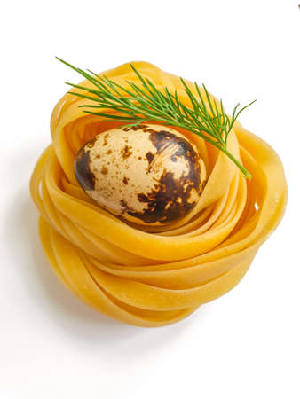 raw pasta, quail egg isolated on white backgroundの写真素材