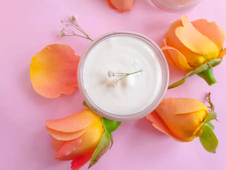 cream cosmetic rose flower on colored background