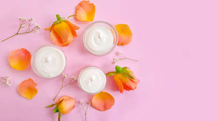 cream cosmetic rose flower on colored backgroundの写真素材