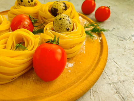 raw pasta, quail egg on a concrete backgroundの写真素材