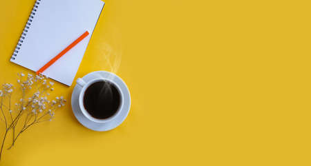 notebook, cup of coffee on a colored background