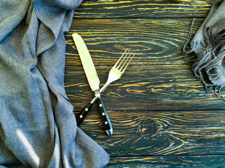 fork, knife towel on old wooden backgroundの写真素材
