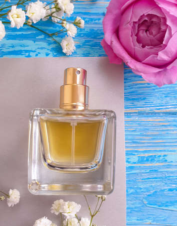 bottle perfume flower on a wooden background