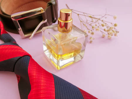 bottle of perfume, belt on colored backgroundの写真素材