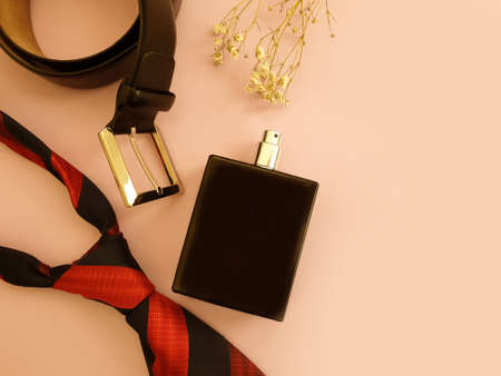 bottle of perfume, belt on colored background