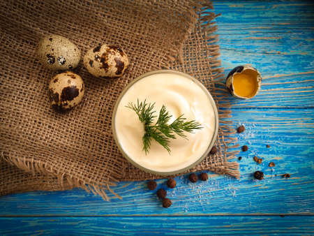 homemade mayonnaise, quail eggs on wooden background