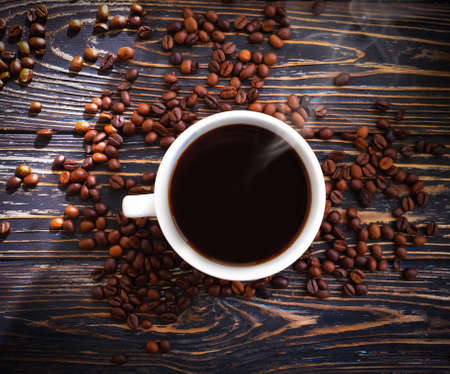 Coffee and roasted coffee beans on a wooden background