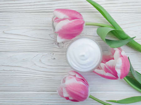 cream cosmetic flower tulip on wooden backgroundの写真素材