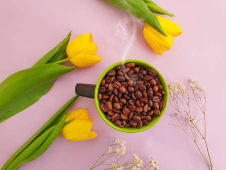 cup of coffee. tulip flower on colored backgroundの写真素材