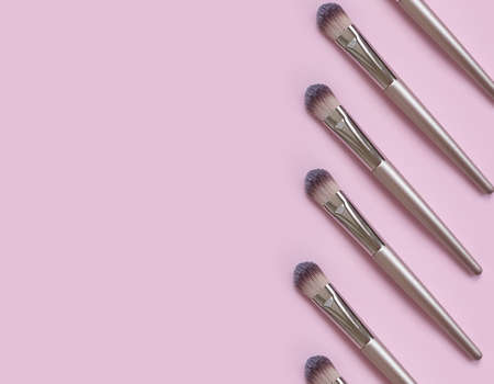 makeup brush on colored background