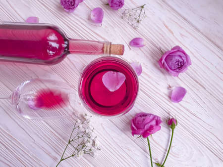 wine glass flower rose on wooden backgroundの写真素材