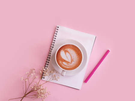 notebook  cup of coffee flower on a colored backgroundの写真素材