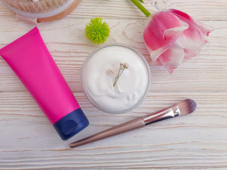 cosmetic cream, tulip flower on wooden backgroundの写真素材
