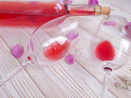 wine glass flower rose on wooden backgroundの写真素材