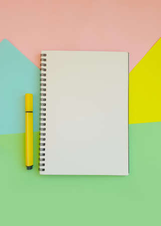 notebook, felt-tip pen on a background of colored paper