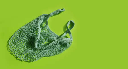 empty mesh eco bag on colored background