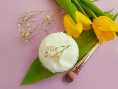 cream cosmetic flower tulip on a colored background