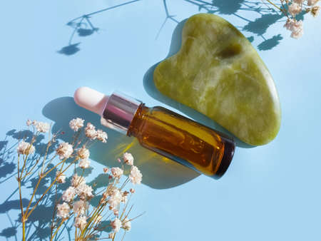 face massager on colored background, gypsophila flowerの写真素材