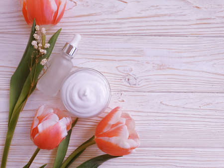 cosmetic cream, tulip flower on wooden backgroundの写真素材