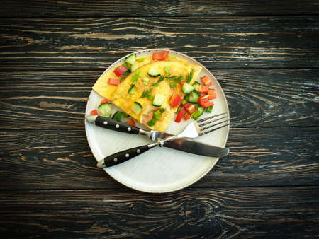 omelet with vegetables on a wooden backgroundの写真素材