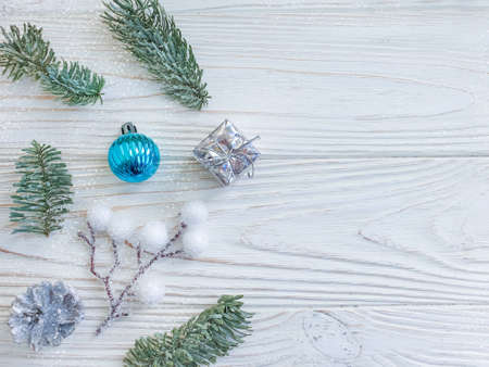 branch of a christmas tree on a wooden background