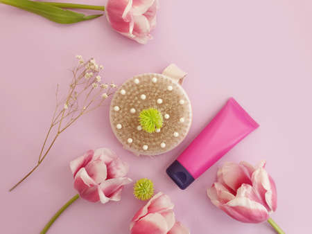 massage brush, flower tulip on colored background