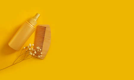 shampoo, wooden comb on a colored backgroundの写真素材