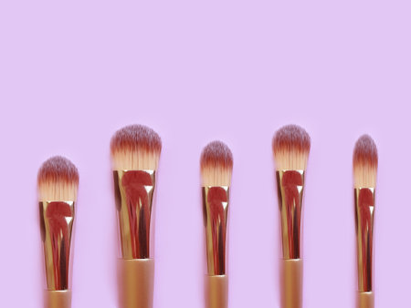 makeup brush on colored background