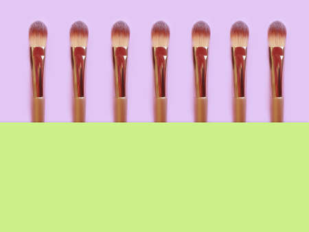 makeup brush on colored background