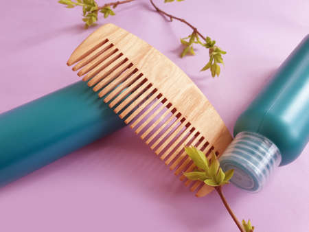 shampoo, wooden comb on a colored background