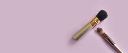 makeup brush on colored background