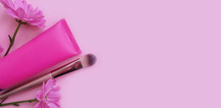 cream cosmetic flower on colored backgroundの写真素材